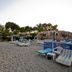 Theodorou Beach Hotel Apartments in Kos with a sandy beach area, sun loungers, and straw umbrellas