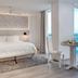 Oleo Cancun Playa in Cancún, beachfront guest room with ocean view, white bed and dining table