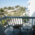 Theodorou Beach Hotel Apartments balcony with table and chairs overlooking greenery and the sea in Kos