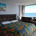 Sea Dip Beach Resort in Daytona Beach room with colorful bed and ocean view through large window