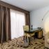 Regalia Hotel & Conference Center room in Lake Ozark with desk, sofa, and large window