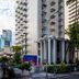Shoreline Hotel Waikiki in Honolulu, tall modern tower with balconies and palm trees