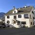 Hotel Arturo in Celerina/Schlarigna, exterior view of a white alpine building with mountain backdrop