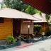 Kerala Bamboo House in Varkala: bamboo cottage with corrugated roof, shaded porch, and tropical greenery