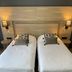 Hôtel Le Mas del Pechs, Sarlat-la-Canéda: twin beds with headboard and wall lamps
