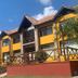 Tierra Merlina in Villa de Merlo, yellow lodge-style hotel exterior with balconies and tiled roof