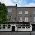 The Red Lion hotel in Doncaster, a three-story stone building with a large tree outside