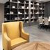 Delta Hotels by Marriott Seattle Everett meeting room with long conference table, shelving wall, and mustard chair