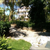 Coco Plaza in Las Terrenas with tropical garden, palm trees and sunlit landscaping
