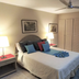 Coco Plaza in Las Terrenas bedroom with bed, lamps, ceiling fan, and closet doors