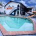 Miami Shore in Miami: outdoor pool beside a motel building with palm trees and lounge chairs