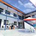 Miami Shore in Miami with outdoor courtyard, patio tables and chairs, and second-floor balconies