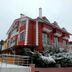 Ay Isigi Hotel in Şile, Turkey, red hotel exterior with snow-covered shrubs and ramp