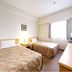HOTEL AZ Fukuoka Itoshima guest room with two single beds, TV, window and dresser