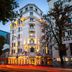 Mercure Belgrade Excelsior hotel exterior in Belgrade at dusk with illuminated facade and street traffic