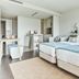 The Pearl Troia in Tróia: modern twin-bed hotel room with a sitting area and framed wall art