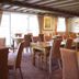 The Anchor Inn in Bristol dining room with wooden tables, upholstered chairs and exposed beam ceiling