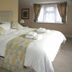 The Anchor Inn in Bristol bedroom with king bed, patterned headboard, and window with curtains