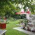 The Anchor Inn, Bristol garden with picnic tables under trees and a stone path