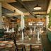 Bahia Principe Luxury Runaway Bay restaurant with booth seating, set tables, and open kitchen