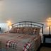 Hadovka Inn in Wellington guest room with plaid bed, bedside lamps and sitting area under sloped ceiling