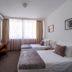 Garni Hotel Le Petit Piaf in Belgrade room with two twin beds, desk and large window