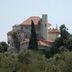 Le Château des Oliviers in Tripoli, hilltop hotel with terracotta roofs and surrounding trees