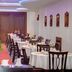 Susuzlu Seçkin Otel in Izmir dining room with round tables, dark chairs, and a red carpet aisle