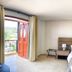 Hotel Majam's Resort in San Gil room with king bed, balcony doors, and hillside view