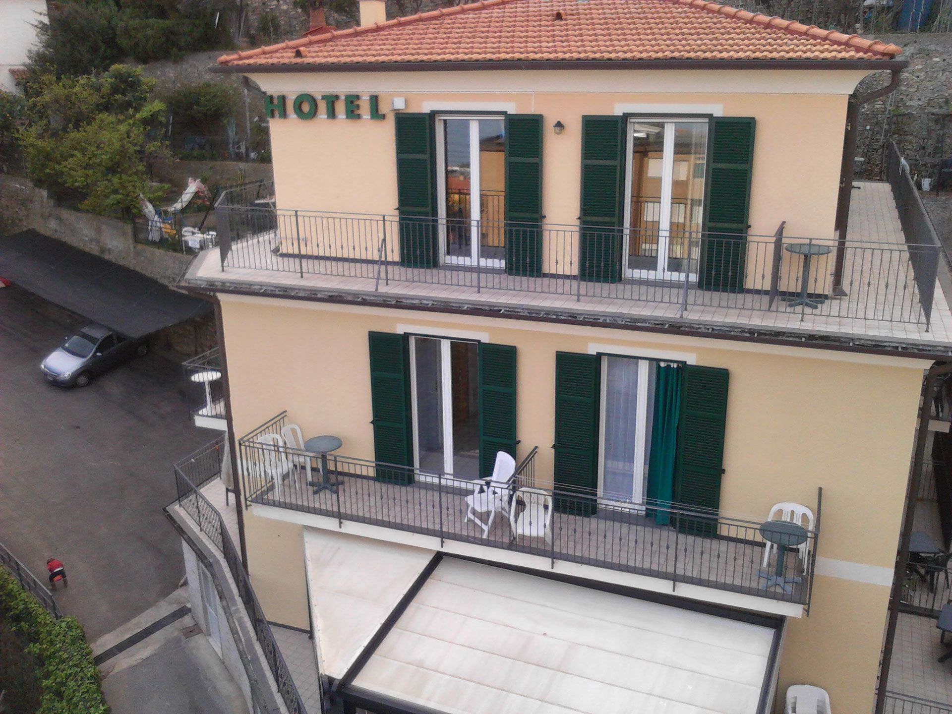 Hotel Adriana in Laigueglia with balconies, green shutters and a tiled roof