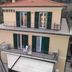 Hotel Adriana in Laigueglia with balconies, green shutters and a tiled roof