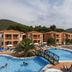 Kustur Club Holiday Village in Kusadasi with a large outdoor pool, bridge, and sun loungers