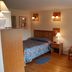 Grand View Motel in Wilmington guest room with bed, bedside lamp and two chairs