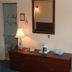 Grand View Motel in Wilmington guest room with dresser, lamp, mirror and coffee maker near a bathroom doorway