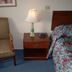 Grand View Motel in Wilmington guest room with chair, nightstand, lamp, and floral bedspread