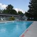 Grand View Motel in Wilmington with an outdoor pool, lounge chairs, and trees beside the motel