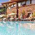 Hotel Parque Tropical in Maspalomas with a large outdoor pool and palm trees beside sun loungers