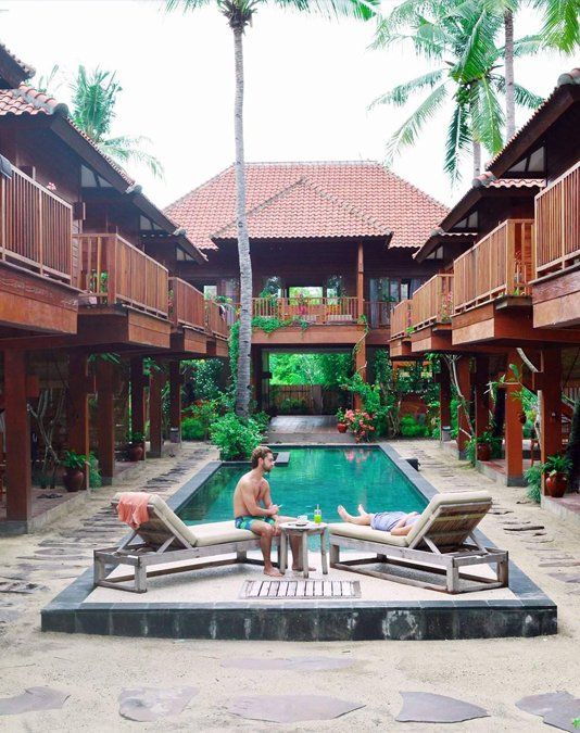 Hotel Villa Bagus in Pemenang courtyard pool with lounge chairs and palm trees