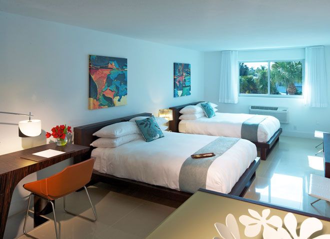 Beach Haus Bal Harbour guest room with two beds, desk, and window view in Bal Harbour