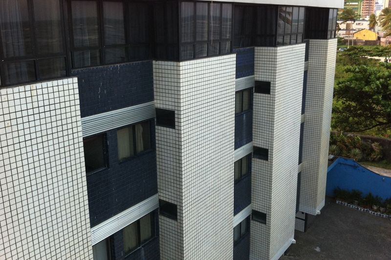 Hotel Monza Vip in Recife exterior with tiled facade, windows, and nearby trees