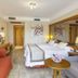 Gf Fañabe in Adeje guest room with bed, sofa, TV, and mirrored wall