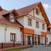 Hotel Magiczny Zakatek in Kędzierzyn-Koźle, exterior of a multi-gabled hotel with red roof and brick walkway