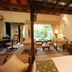 Lagoon Bay-Leonia Holistic Destination in Shamirpet suite with four-poster bed, seating area, and garden view