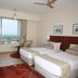 Lagoon Bay-Leonia Holistic Destination in Shamirpet guest room with twin beds and a large city view window
