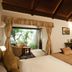 Lagoon Bay-Leonia Holistic Destination in Shamirpet room with king bed, TV, desk and open garden patio