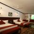 Lagoon Bay-Leonia Holistic Destination room in Shamirpet with two beds, TV, and a window bench seat