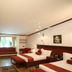 Lagoon Bay-Leonia Holistic Destination room in Shamirpet with two beds, red seating, and a window bench