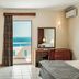Mitsis Family Village Beach Hotel room in Kardamena with balcony sea view, bed, desk and lamp