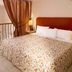 Mitsis Family Village Beach Hotel in Kardamena bedroom with balcony railing and pool view