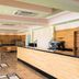 Mitsis Family Village Beach Hotel lobby with wood-paneled reception desk in Kardamena